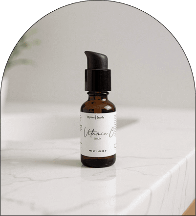 Vitamin C serum bottle on marble counter.