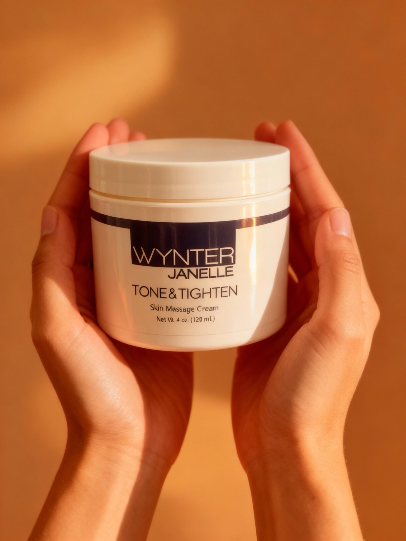 Hands holding skin massage cream container.